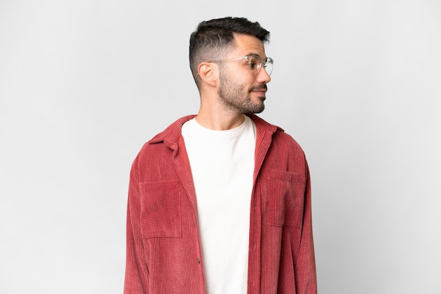 Young handsome caucasian man over isolated white background looking to the side