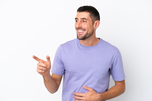 Young handsome caucasian man isolated on white background pointing finger to the side and presenting a product