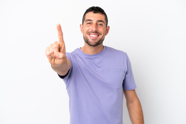 Young handsome caucasian man isolated on white background showing and lifting a finger