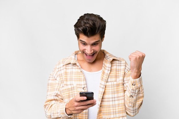 Young handsome caucasian man over isolated white background surprised and sending a message