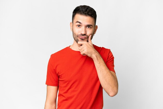 Young handsome caucasian man over isolated white background thinking