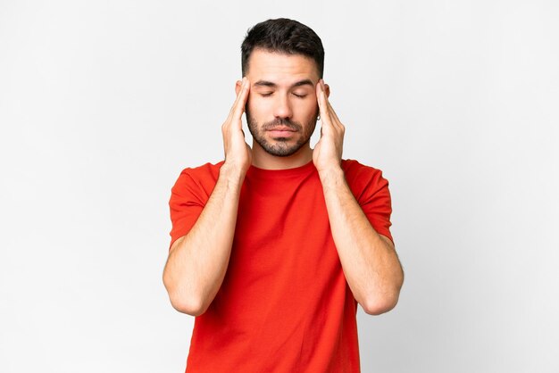 Young handsome caucasian man over isolated white background with headache