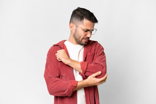 Young handsome caucasian man over isolated white background with pain in elbow