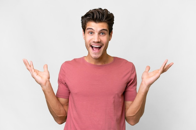 Young handsome caucasian man over isolated white background with shocked facial expression