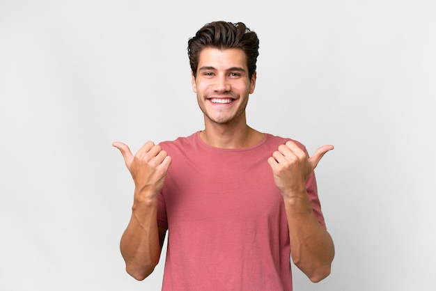 Young handsome caucasian man over isolated white background with thumbs up gesture and smiling