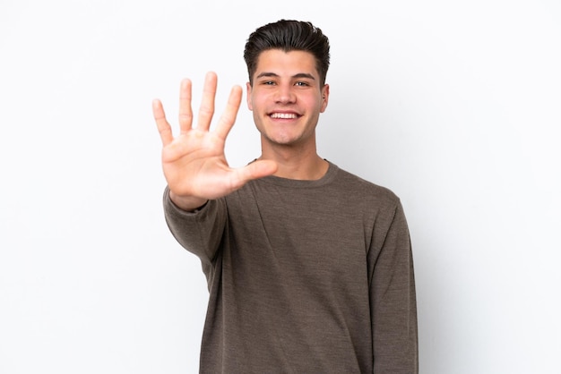 Young handsome caucasian man isolated on white bakcground counting five with fingers