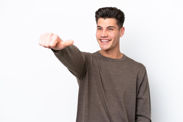 Young handsome caucasian man isolated on white bakcground giving a thumbs up gesture