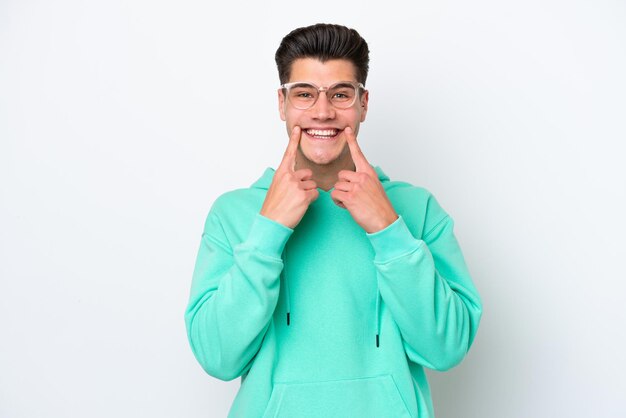 Young handsome caucasian man isolated on white bakcground smiling with a happy and pleasant expression