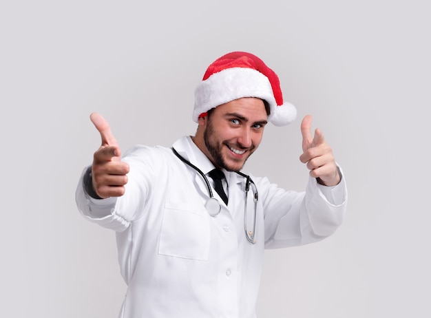 Young handsome doctor in white uniforme and Santa Claus hat