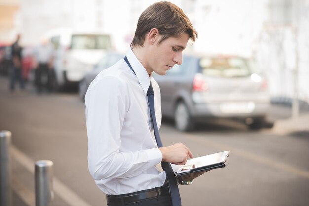 young handsome elegant blonde model man using tablet 