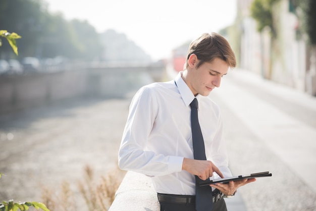 young handsome elegant blonde model man using tablet 