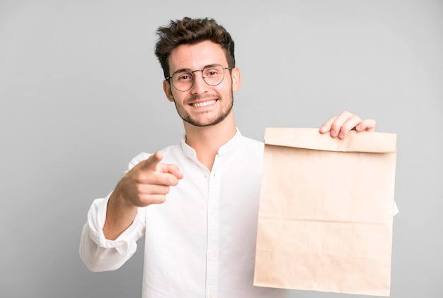 Young handsome employee man with a take away food paper bag