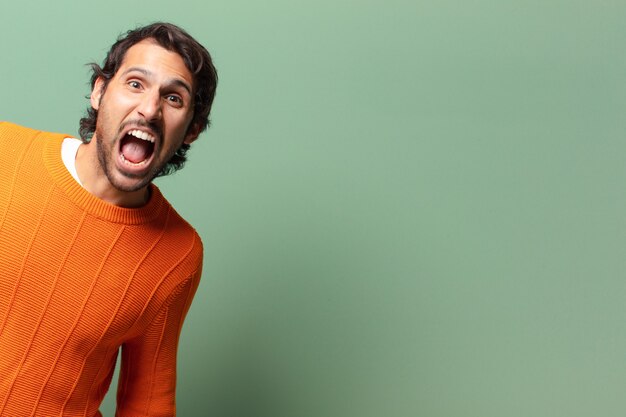 Young handsome expressive and angry indian man with a copy space