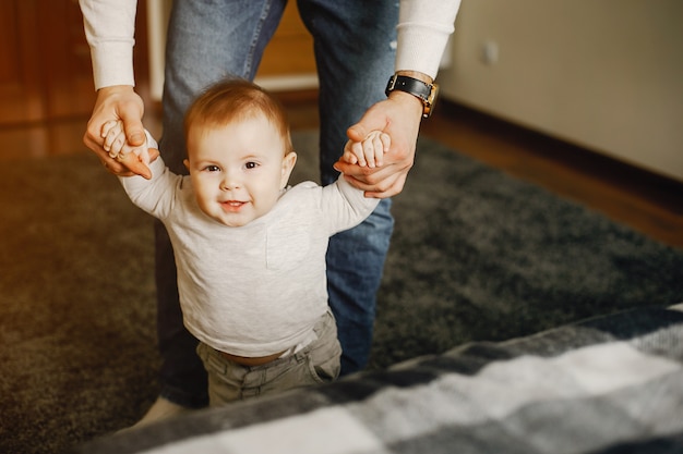 young and handsome father playing with his son at home