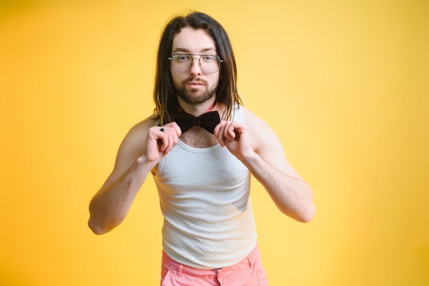 Young handsome gay man on a colored background in the studio LGBT concept