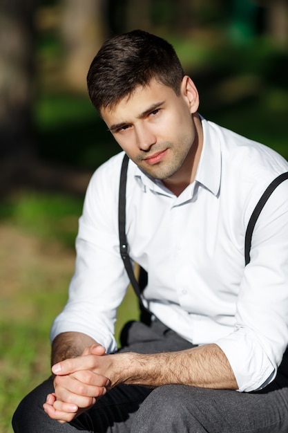 Young handsome groom sitting on a chair