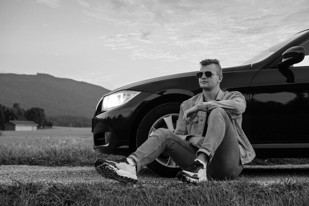 Young handsome guy near his car