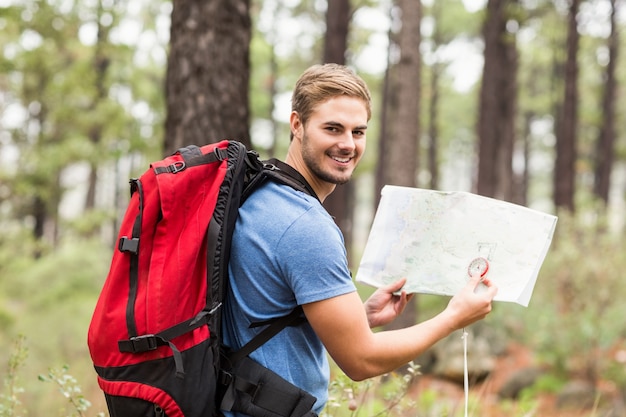 Young handsome hiker using map