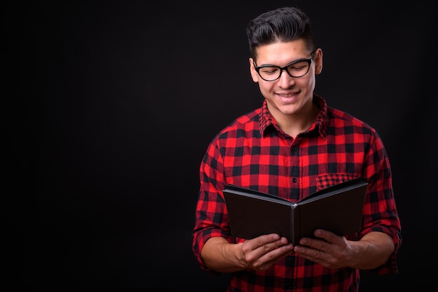 young handsome hipster man on black