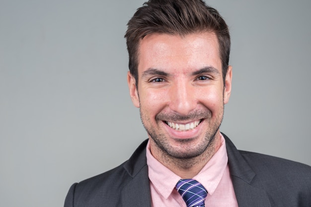 young handsome Hispanic businessman in suit on white