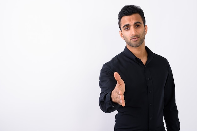 Young handsome Indian businessman against white background