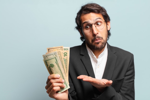 Young handsome indian businessman with banknotes