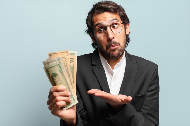 Young handsome indian businessman with banknotes