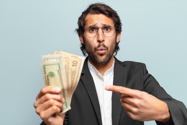 Young handsome indian businessman with banknotes