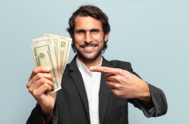 Young handsome indian businessman with banknotes