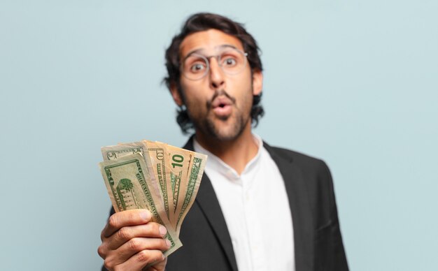 Young handsome indian businessman with banknotes