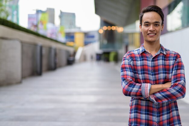 Young handsome Indian man exploring the city of Bangkok, Thailand