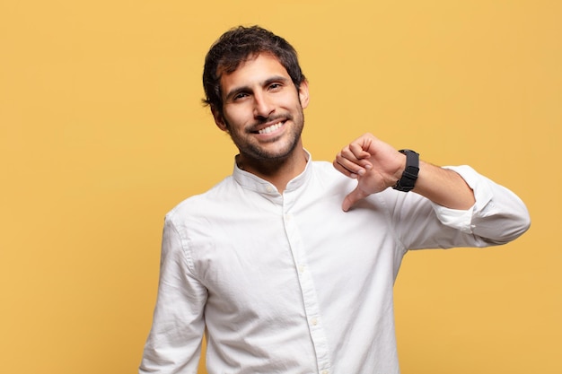 Young handsome indian man happily and proud