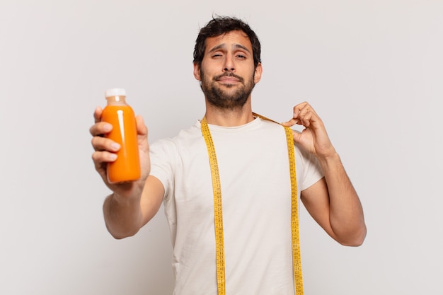 Young handsome indian man happy expression and holding a smoothy