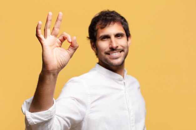 Young handsome indian man. happy and surprised expression