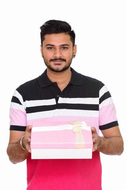 Young handsome Indian man ready for Valentine's day holding gift