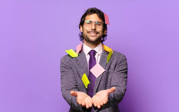 Young handsome indian man smiling happily with friendly