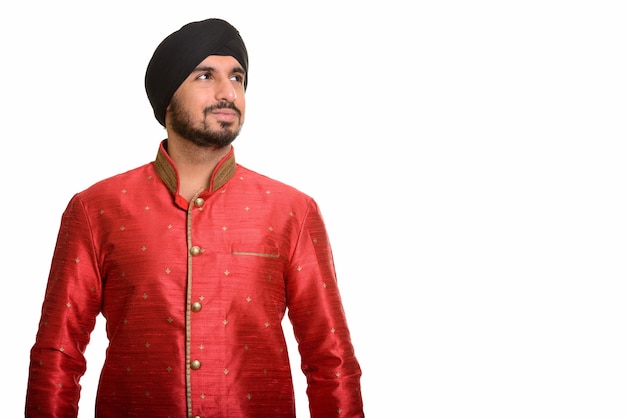 Photo young handsome indian sikh thinking while wearing traditional cl