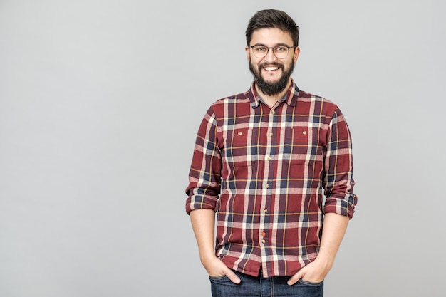 Young handsome male with beard against gray background