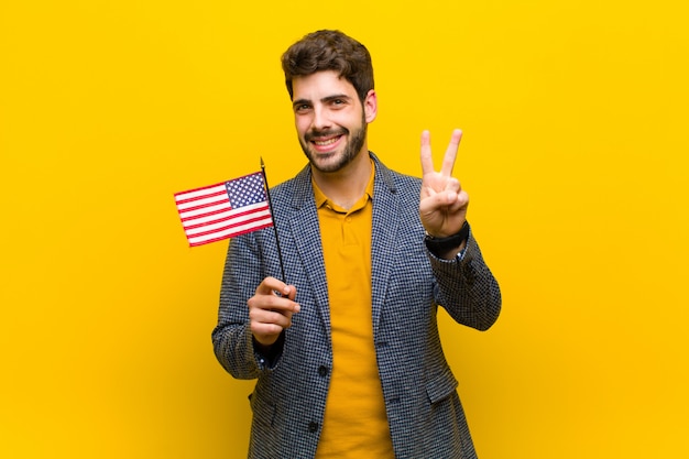 Young handsome man against orange background