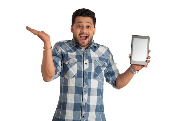 Young handsome man businessman showing a blank screen of a smartphone or mobile or tablet phone on white background