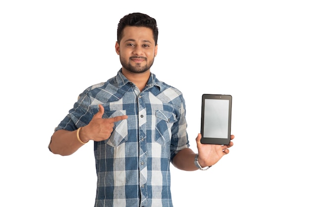 Young handsome man businessman showing a blank screen of a smartphone or mobile or tablet phone on white background