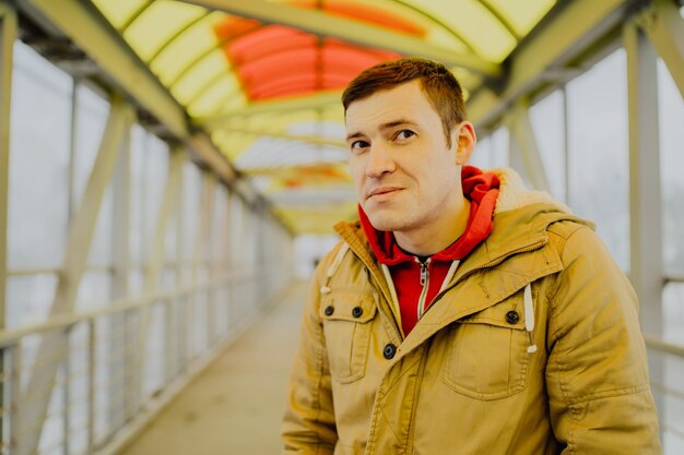 A young handsome man in casual clothes by road the city