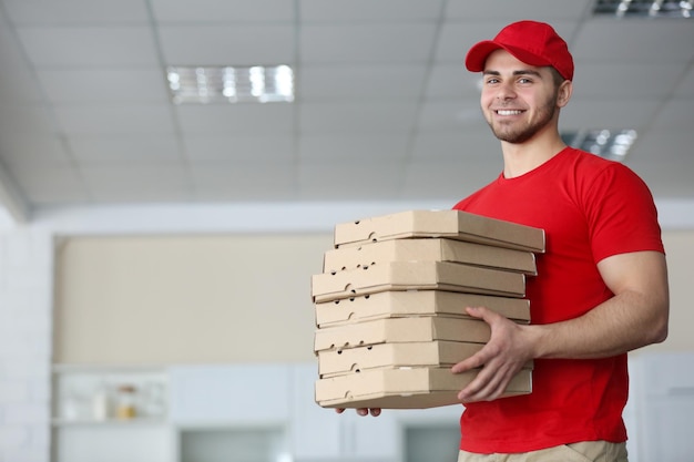 Young handsome man delivering pizza