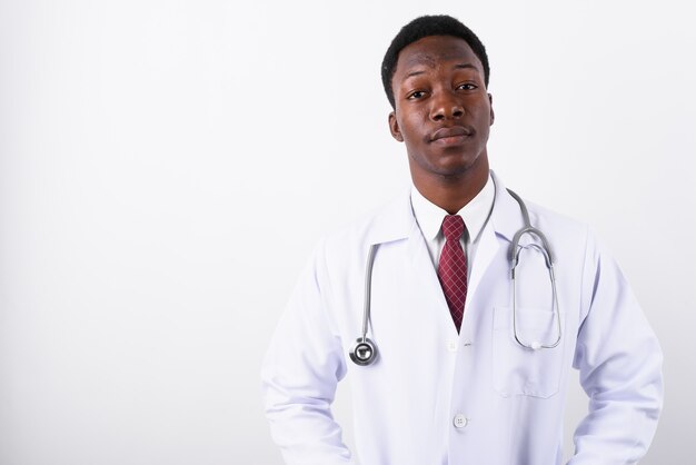 Young handsome man doctor against white