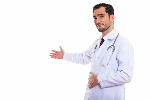 young handsome man doctor showing something on the wall