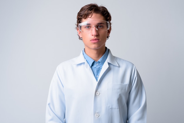 young handsome man doctor wearing protective glasses