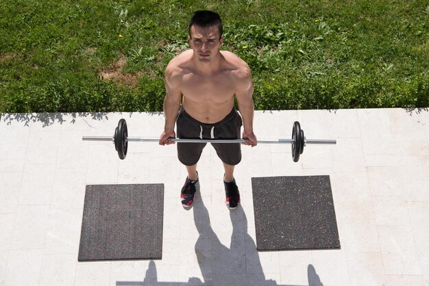 young handsome man doing morning exercises in front of his luxury home villa