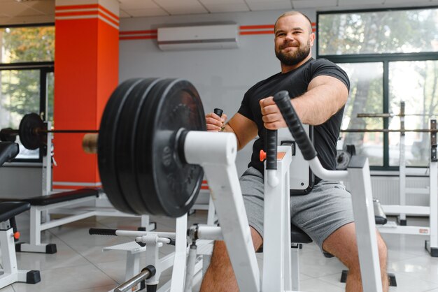 Young handsome man engaged in the gym