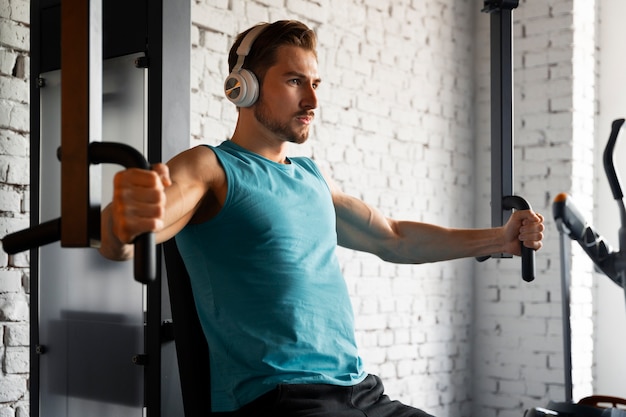 Young handsome man exercising at the gym for bodybuilding