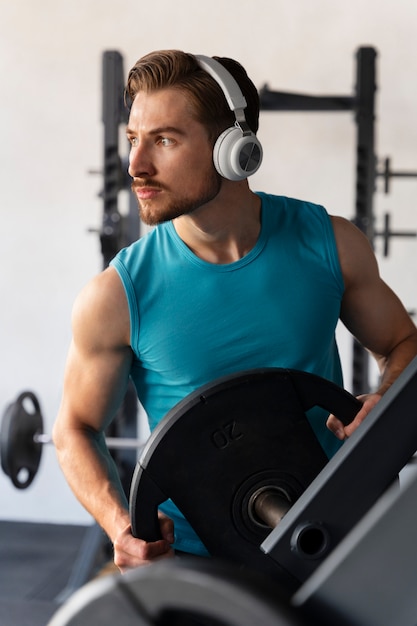 Young handsome man exercising at the gym for bodybuilding